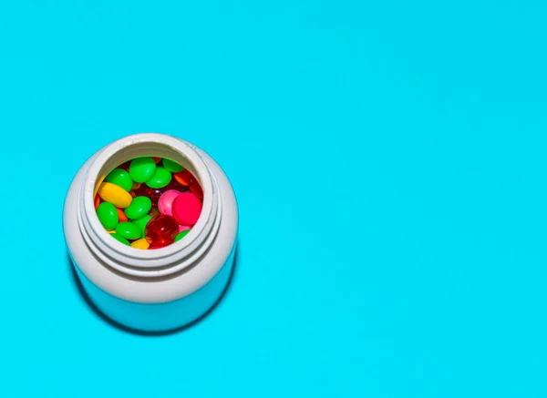 Colorful pills and tabs on the blue background