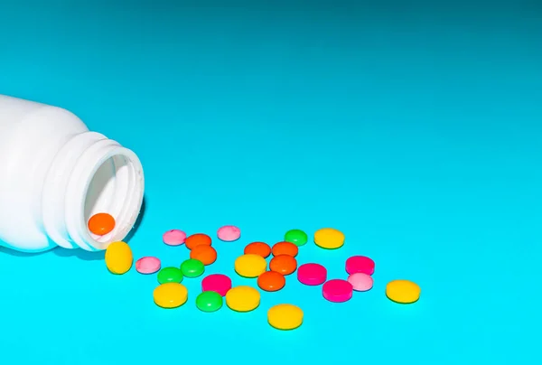 Colorful pills and tabs on the blue background