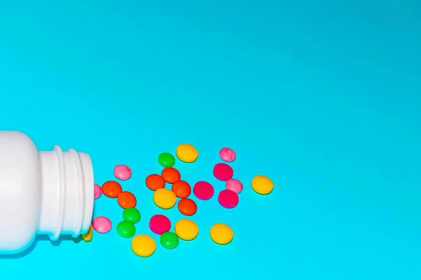 Colorful pills and tabs on the blue background