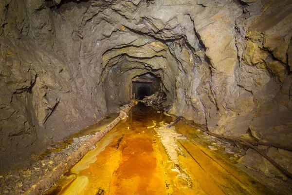 Old abandoned underground gold mine tunnel