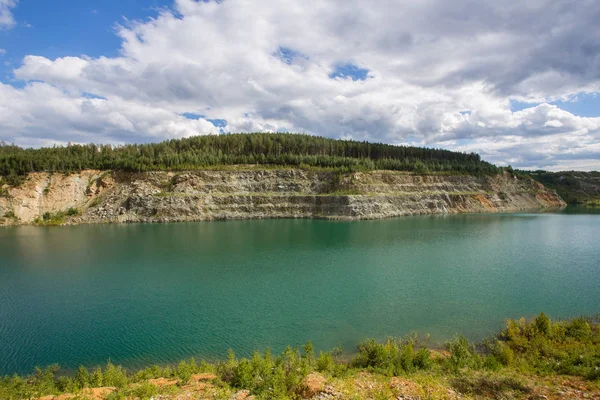 Flooded quarry mine pit blue water