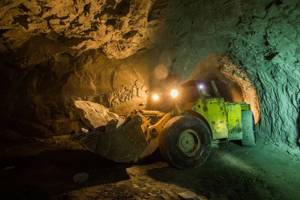 Ore transport machine in underground gold mine shaft tunnel. Mining industry