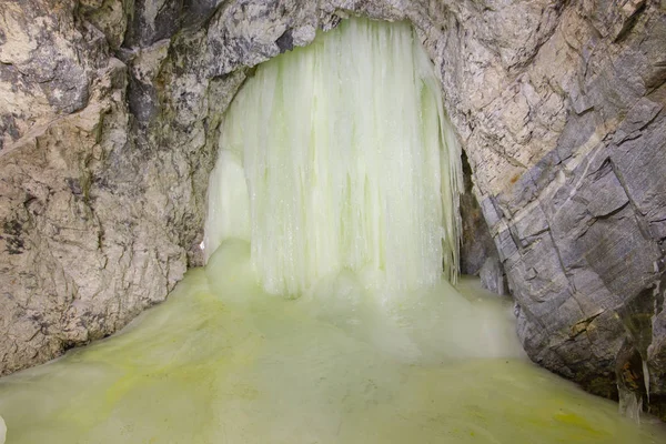 Old underground gold mine shaft tunnel with ice stalactites stalagmites