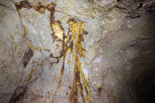 Smudges of minerals in underground abandoned gold iron ore mine tunnel