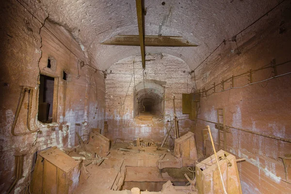 Ore crusher room in old mine underground tunnel