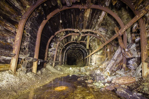 Underground gold iron mine shaft tunnel drift with metal timbering