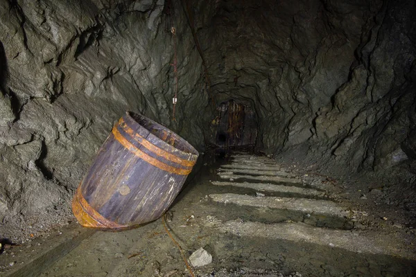 Underground abandoned ore mine shaft tunnel gallery with keg
