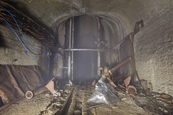 地下鉱山の光とシャフト底のロッジケージ — ストック写真