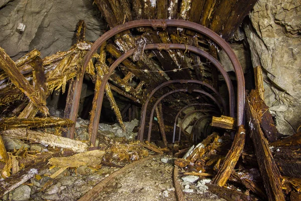 Underground gold iron mine shaft tunnel drift with metal timbering collapsed
