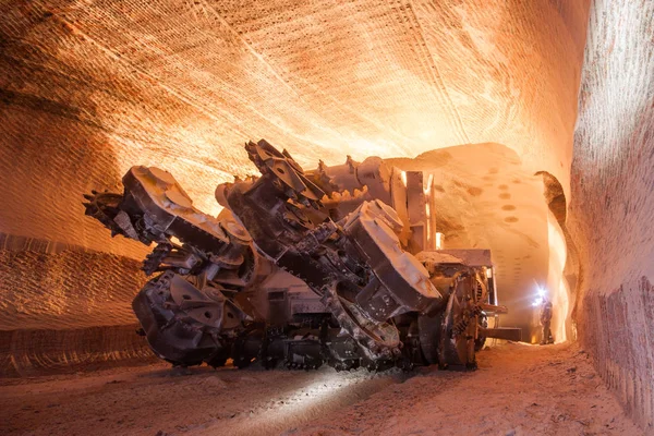 Underground salt potash mine tunnel with harvester machine