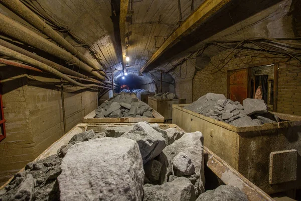 Mining cart wagon with gold ore in underground mine