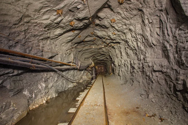 Underground gold mine shaft tunnel drift with rails