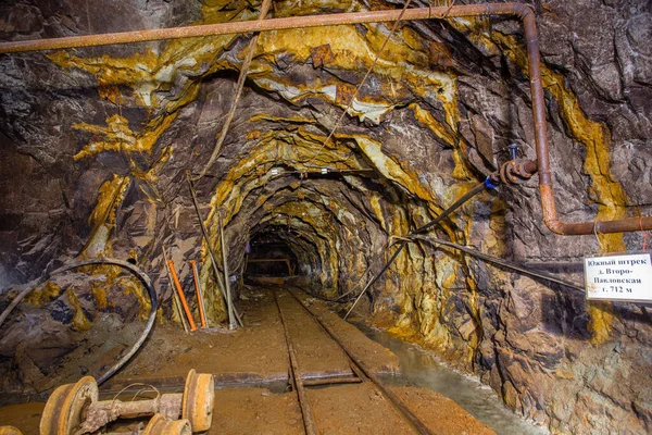 Underground gold mine shaft tunnel drift with rails