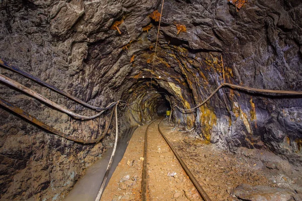 Underground gold mine shaft tunnel drift with rails