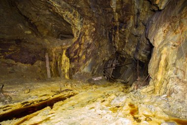 Terk edilmiş bakır madeni, yer altı tüneli ve sarı toprak.