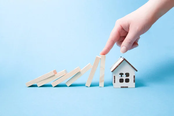 Hand Stops Falling Wooden Dominoes Falling House Model Real Estate — Stock Photo, Image