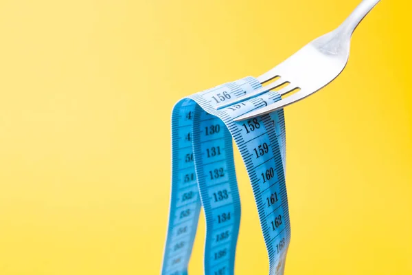 Niebieska Taśma Pomiarowa Widelcu Jak Pasta Żółtym Tle Koncepcja Diety — Zdjęcie stockowe