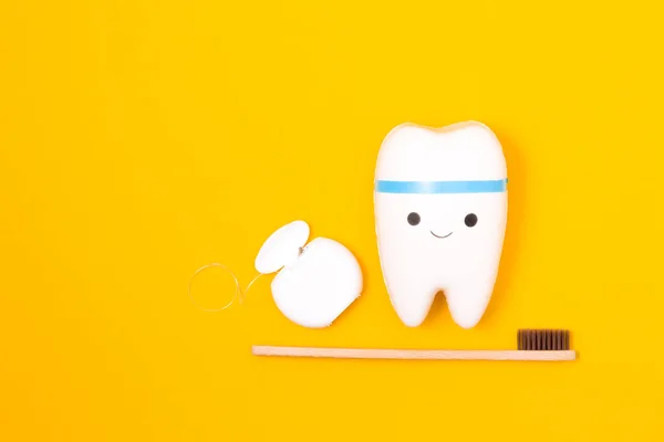 Tooth Model Dental Floss Bamboo Toothbrush Yellow Background Happy Tooth — Stock Photo, Image