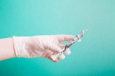 Cam test tüpünde yüz dolarlık banknot, tek kullanımlık beyaz plastik eldivenli bir el yeşil arka planda test tüpü tutuyor, kopyalama alanı, 2020 krizi, ABD 'de koronavirüs salgını.