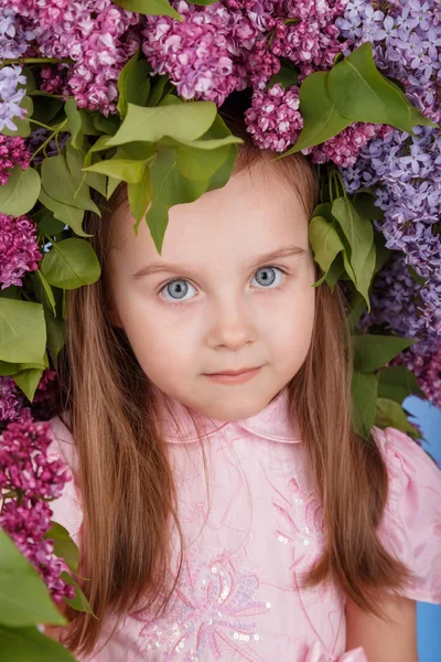 Beautiful girl with the lilac spring wreath — Stock Photo, Image