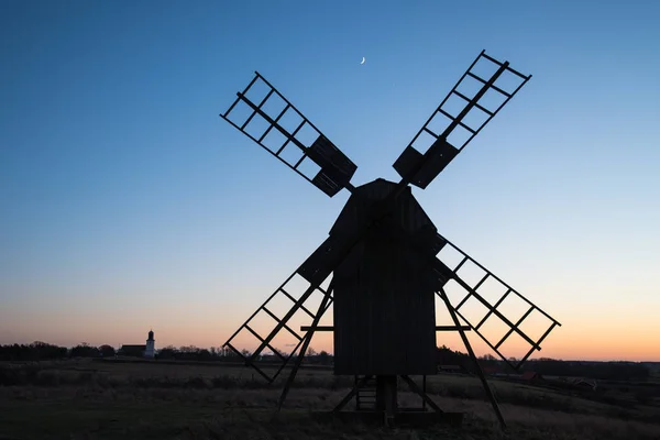 Traditional windmill and a church silhouettes — Stock Photo, Image