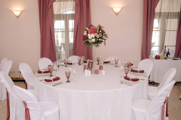 Wedding guest table decorated with bouquet and settings