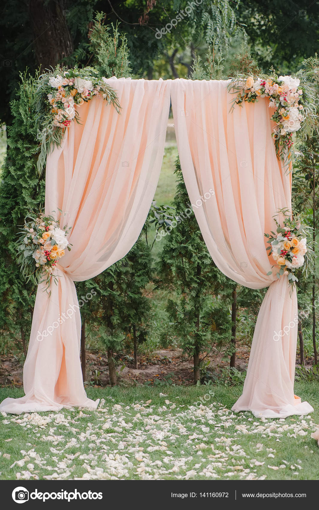 Beautiful wedding archway. Arch decorated with peachy cloth and flowers