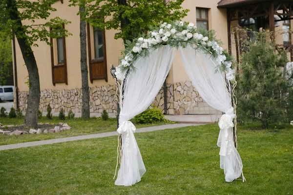 Beautifully decorated entrance arch in front of wedding hall