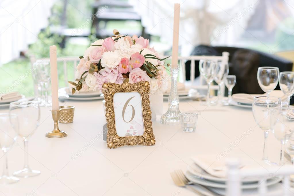 Guest numbered table with with adorable bouquet, closeup