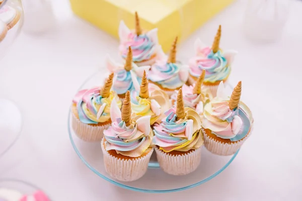 Unicorn fondant cupcakes frosting with butter cream pastel color served on transparent plate — Stok fotoğraf