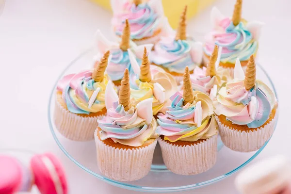 Unicorn fondant cupcakes frosting with butter cream pastel color served on transparent plate — Stok fotoğraf