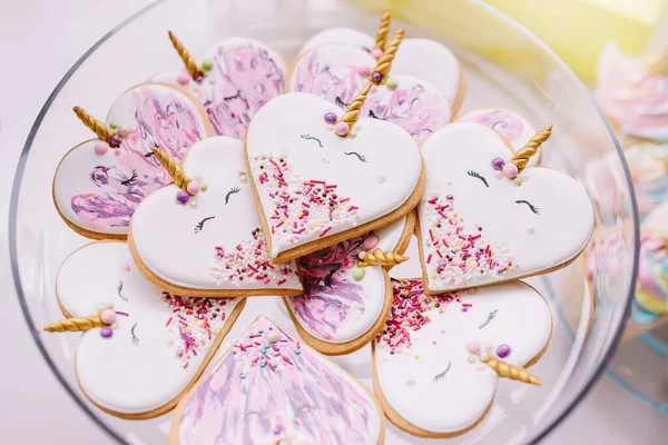 Gingerbread cookies covered with multi colored icing in pale pastel colors shaped as heart unicorn.Birthday cakes — Stock Photo, Image