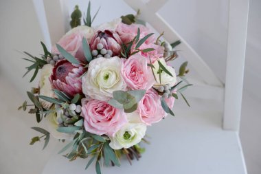 Exotic bouquet of rose and white flowers on a white background. Background for wedding invitations