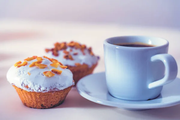 Morning coffee with Muffins on light table. Close up.