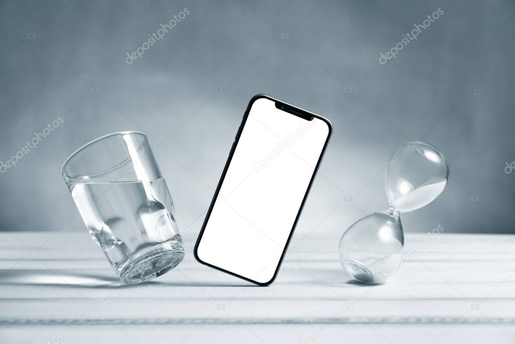Smartphone mockup, phone with blank screen flying under the table. Symbol of lightness freshness airiness. Modern technologies social networks and applications. Copy space
