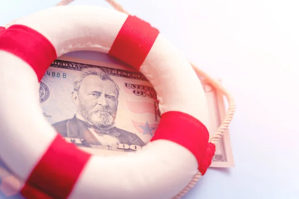 Abstract fast emergency rescue business financial economics crisis. Concept of fix economy financial crisis in USA or global world economy. Lifebuoy on US dollar paper banknote bill background.