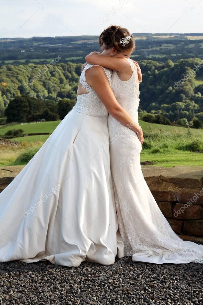 Two Beautiful Brides Kissing Holding Each Other Same Sex