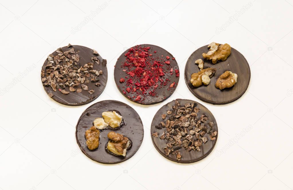 Chocolate medals with different crumbs. Sweet present