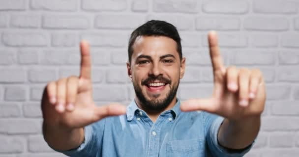 Expressões faciais de jovem barba homem na parede de tijolo — Vídeo de Stock