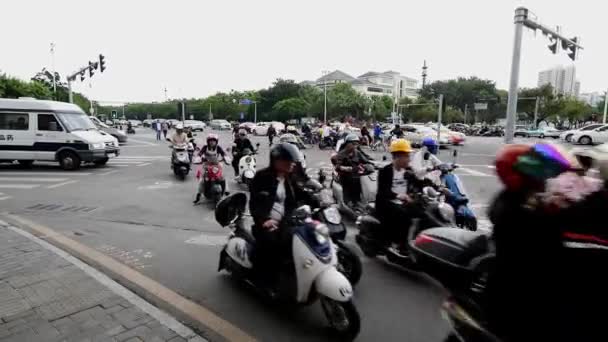 Sanya, China - December 11, 2019: 4K video of Electric Scooters crossing street — Stock Video