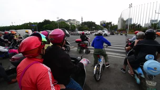 Sanya, China - 11 de diciembre de 2019: 4K video de Scooters eléctricos cruzando la calle — Vídeo de stock