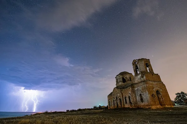 Lighting at Night starry sky near destroyed abandoned Cathedral, HDR