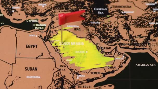 Persona con una moneta da un dollaro cancellare nero gratta e vinci mappa di viaggio dell'Arabia Saudita — Video Stock