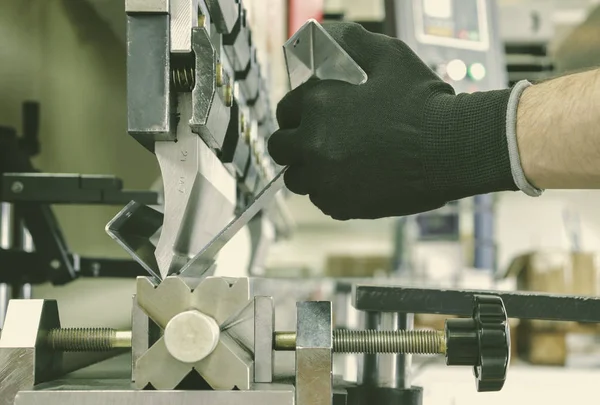 bending metal on a sheet bending machine, at the factory