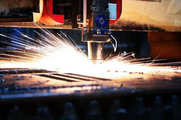 Bright flash from an industrial laser that cuts a sheet of metal. Industrial laser at work in production.