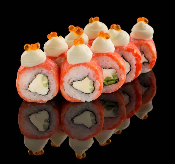 Uramaki Sushi roll with salmon, cheese, cucumber, sauce and caviar on top isolated on black background with reflection — Stock Photo, Image