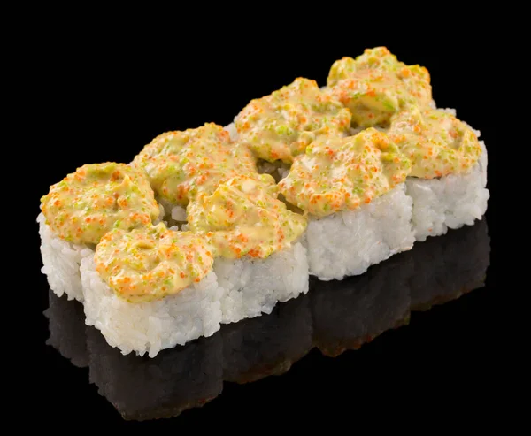 Uramaki Sushi roll isolated on black background with reflection. Sauce with tobiko caviar on top of sushi — Stock Photo, Image