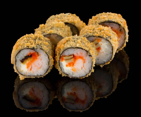 Hot Fried Uramaki Sushi roll with shrimp, omelet, cheese and tobiko caviar isolated on black background with reflection — Stock Photo, Image