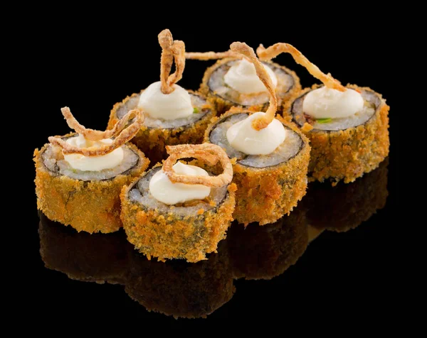 Hot Fried Uramaki Sushi roll with sauce fried onion on top isolated on black background with reflection — Stock Photo, Image