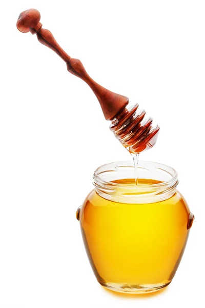 Golden honey in a jar with a wood honey dripper tuangkan honey — Stok Foto